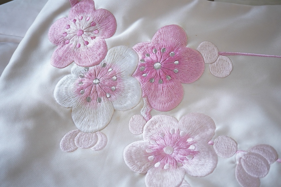 A Japanese pale pink silk floral and metallic thread bird embroidered wedding kimono, 184cm long.